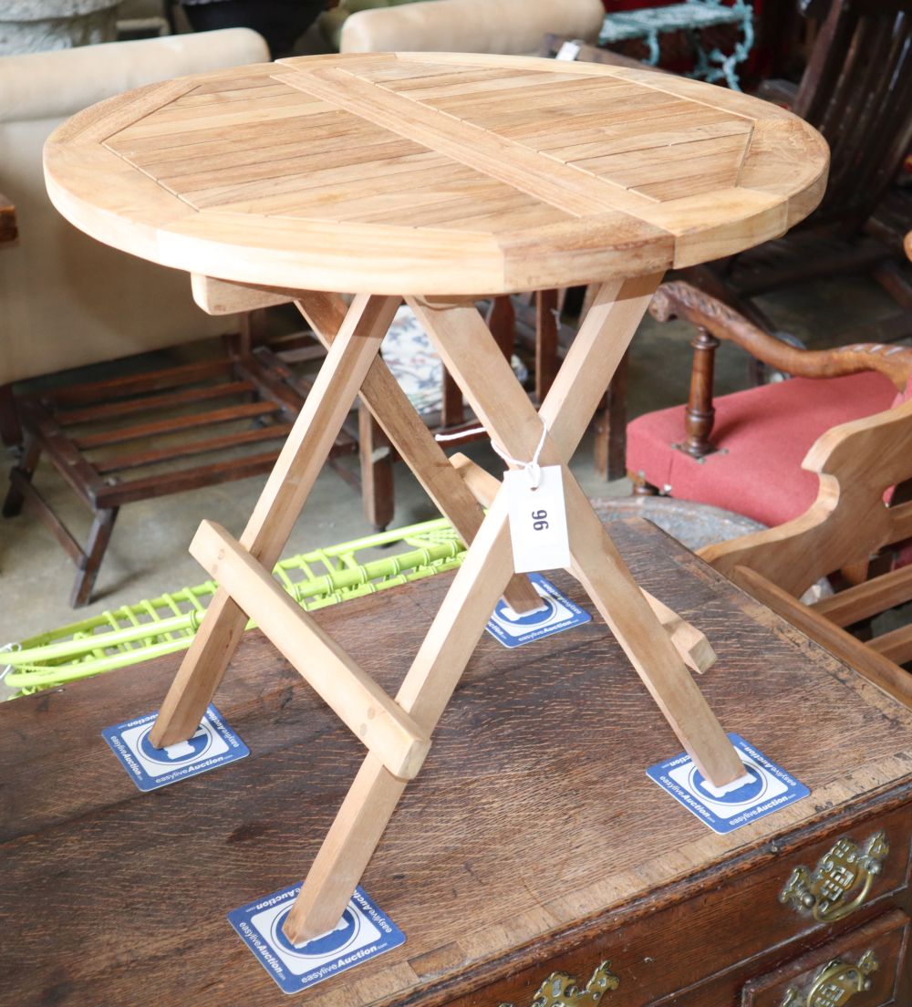 A teak folding garden table, diameter 50cm, H.50cm